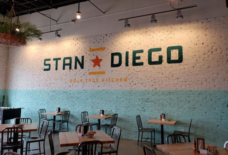 Restaurant interior with logo on brick wall